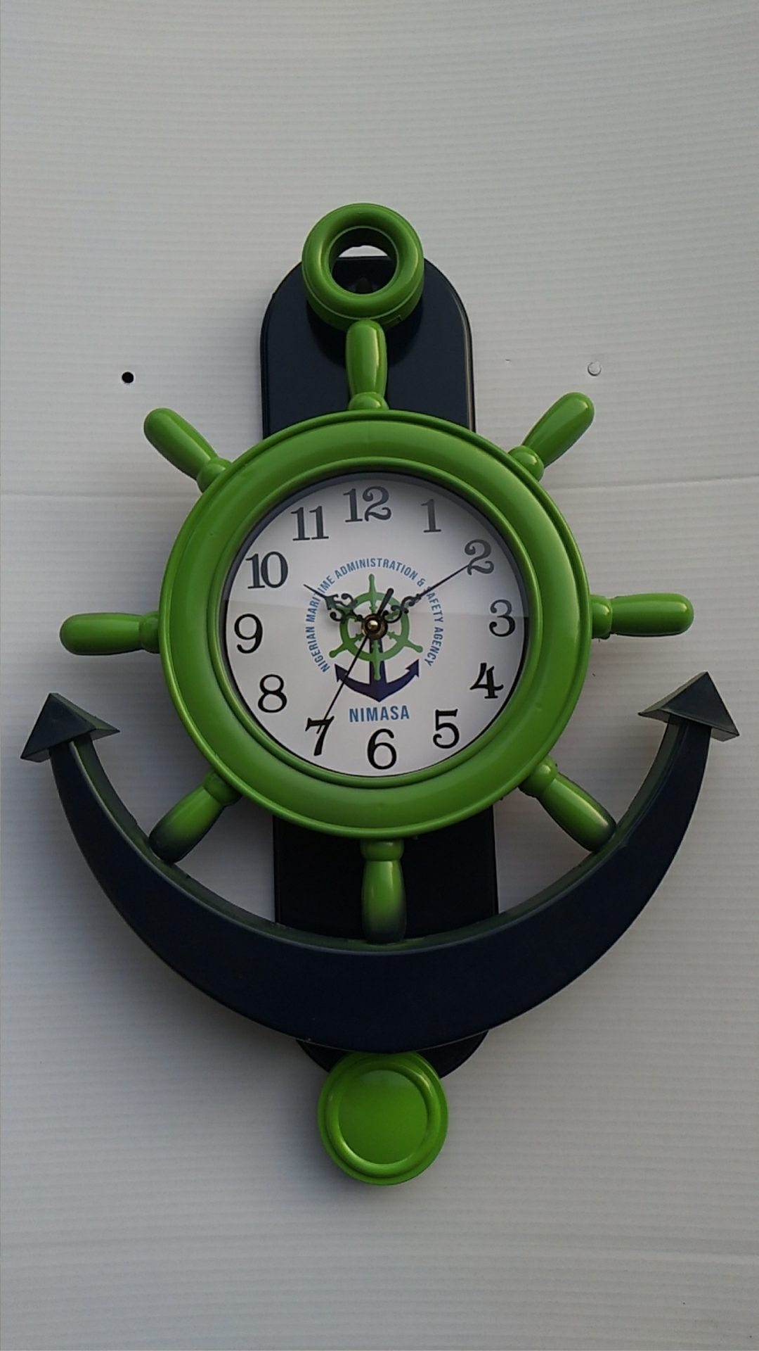 NIMASA anchor shaped custom wall clock with green ship wheel frame
