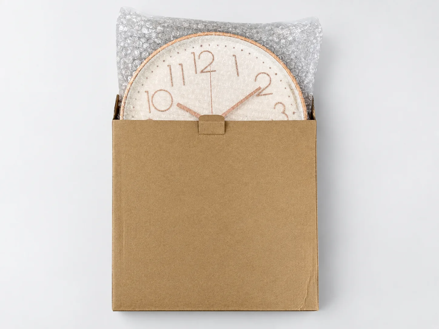 Custom wall clock protected with bubble wrap inside a kraft shipping box